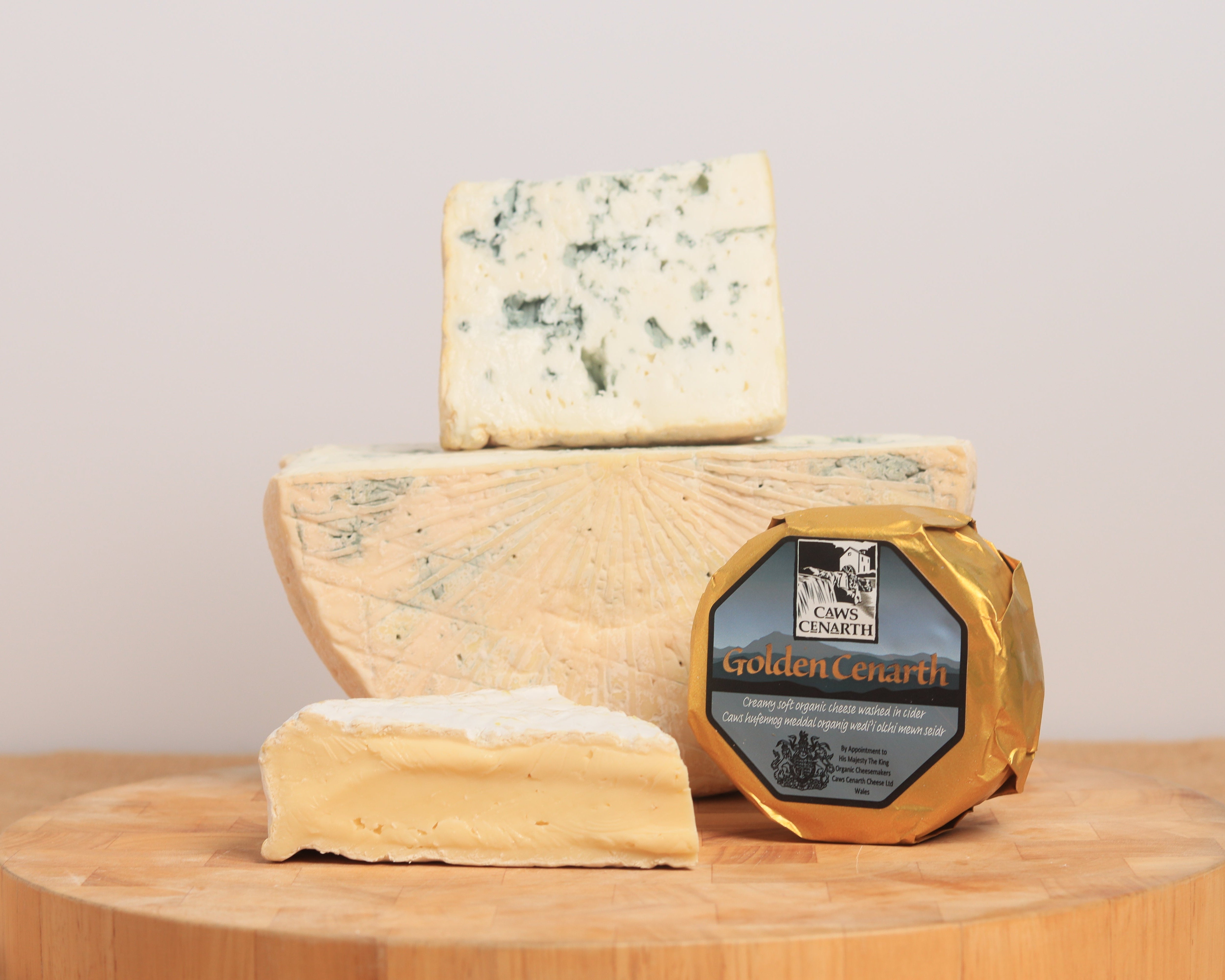 A wedge of Perl Wen, half a wheel of Angel No. 12 with a wedge and a Golden Cenarth