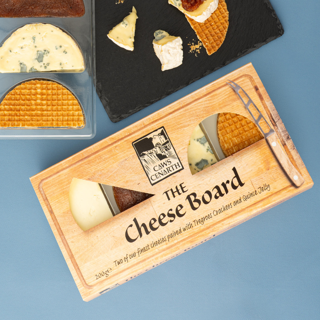 Cheese board set with two types of cheese and a knife on a blue background