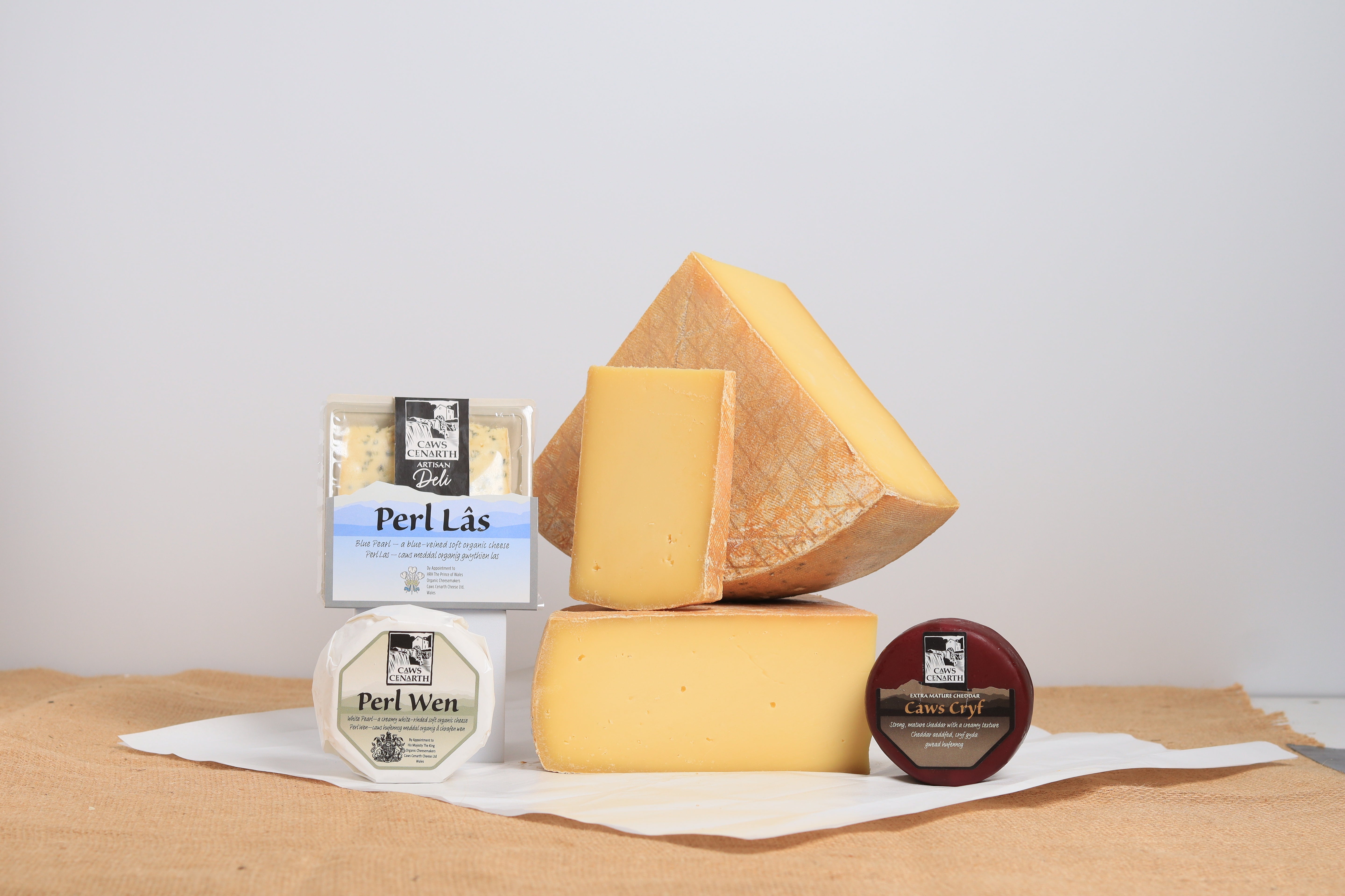 4 assorted caws cenarth cheeses on a wooden surface